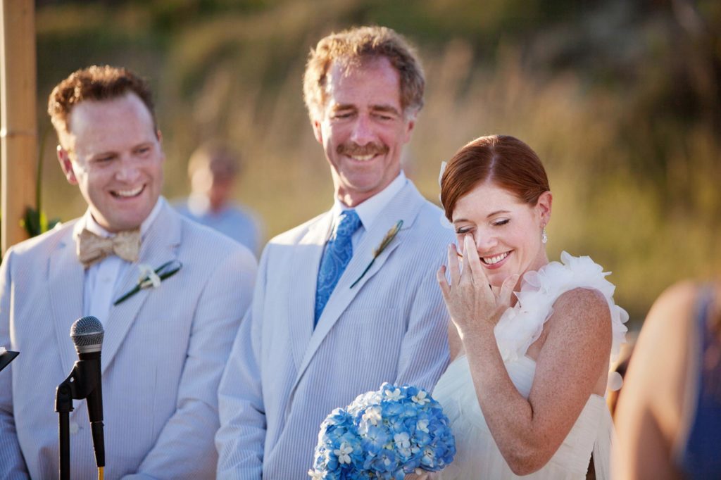 Bride crying during wedding ceremony on the beach in Salter Path, NC