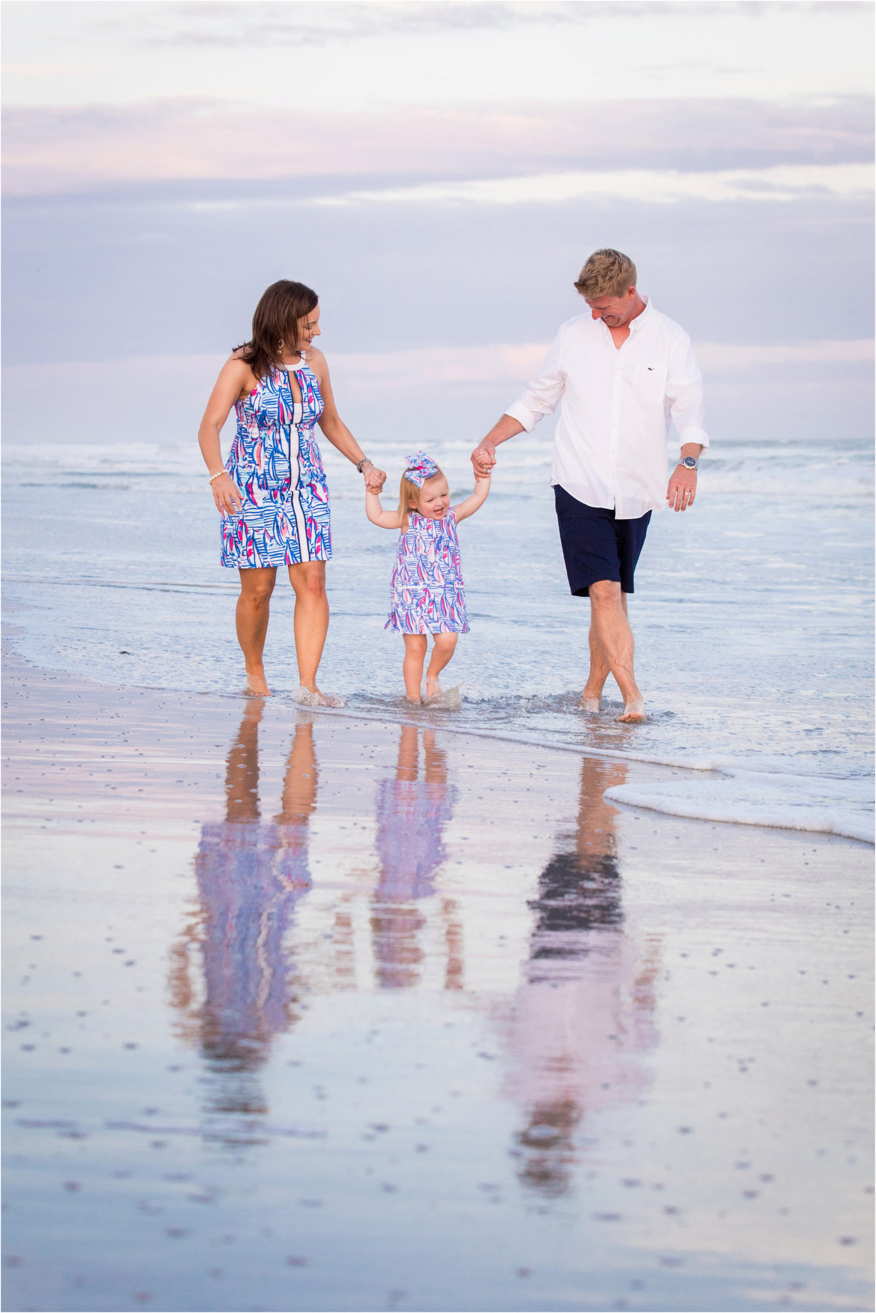 small family walking along beach